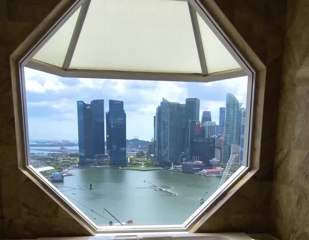 Soaking tub by the octagonal window at The Ritz-Carlton, Singapore